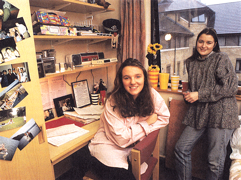 Two females students pose in a halls bedroom