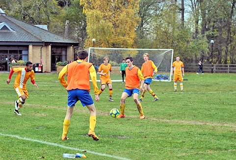 Game of football with the Pavilion building behind