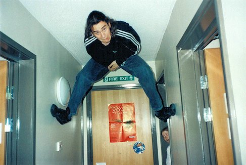 A student high up with feet either side of a corridor!