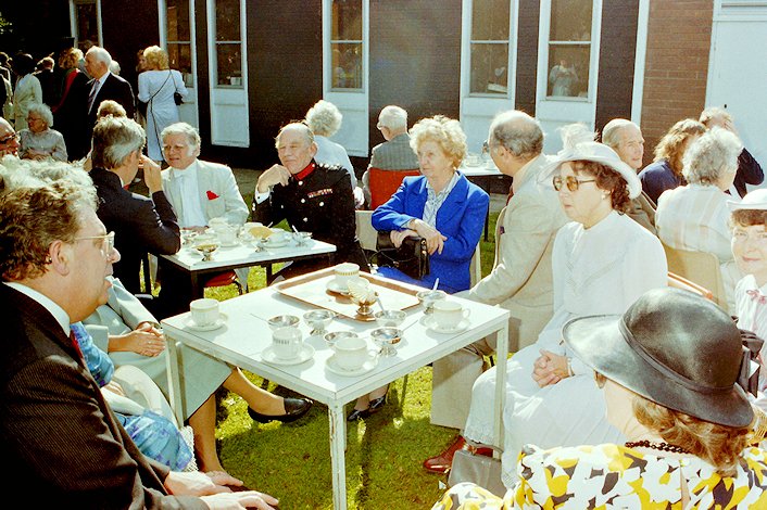 Joan Hickson with dignitaries sitting in the sunshine