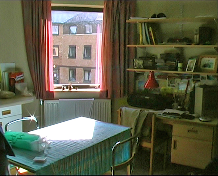 An undergraduate student warden room - table, desk, shelves and view to courtyard