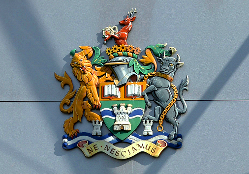 College crest in sunshine on front of Senate